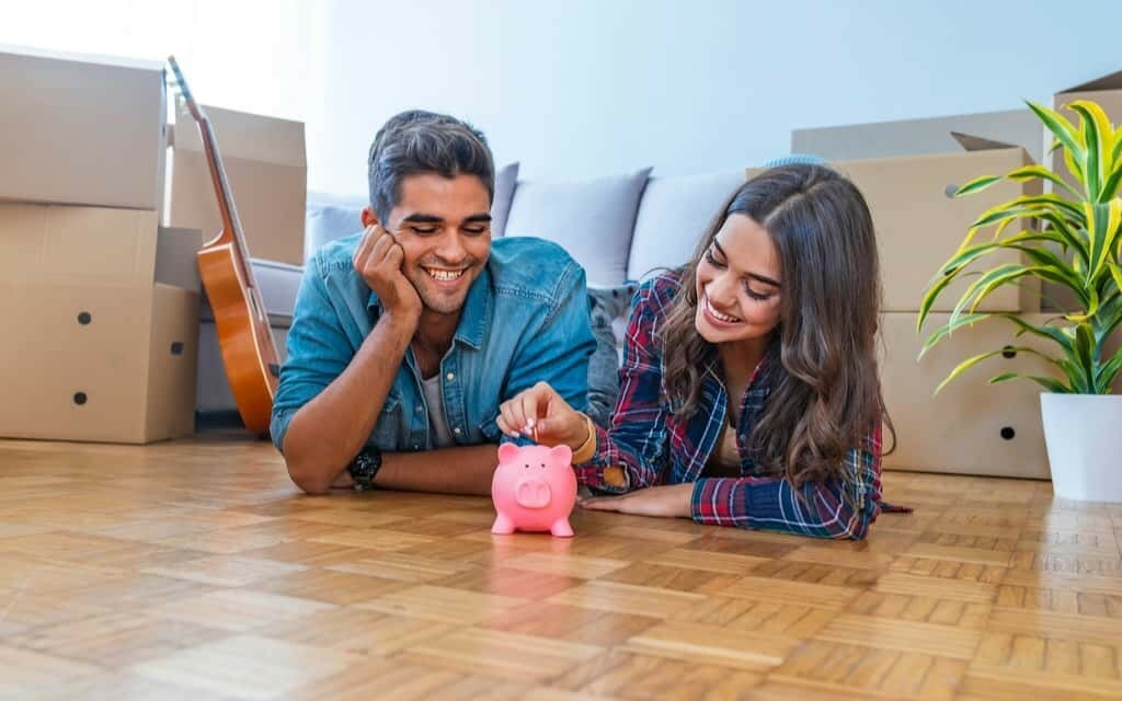 indian couple saving piggy bank